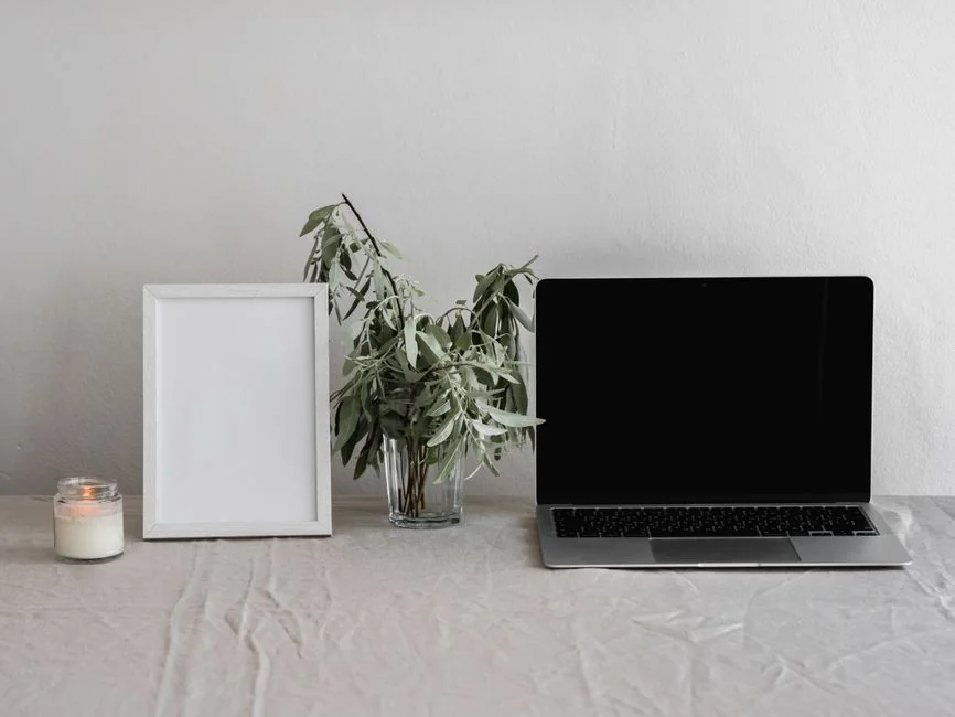 Dual monitors on a desk, showcasing web design in a modern office setting.